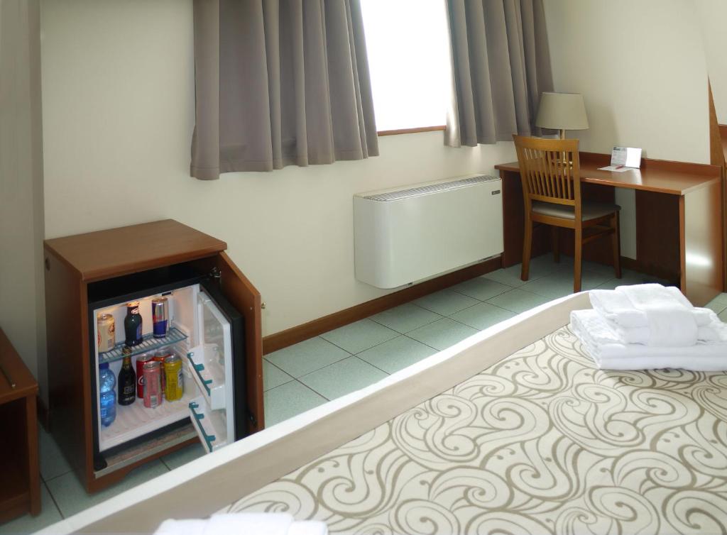 Postel nebo postele na pokoji v ubytování ALA Hotel
