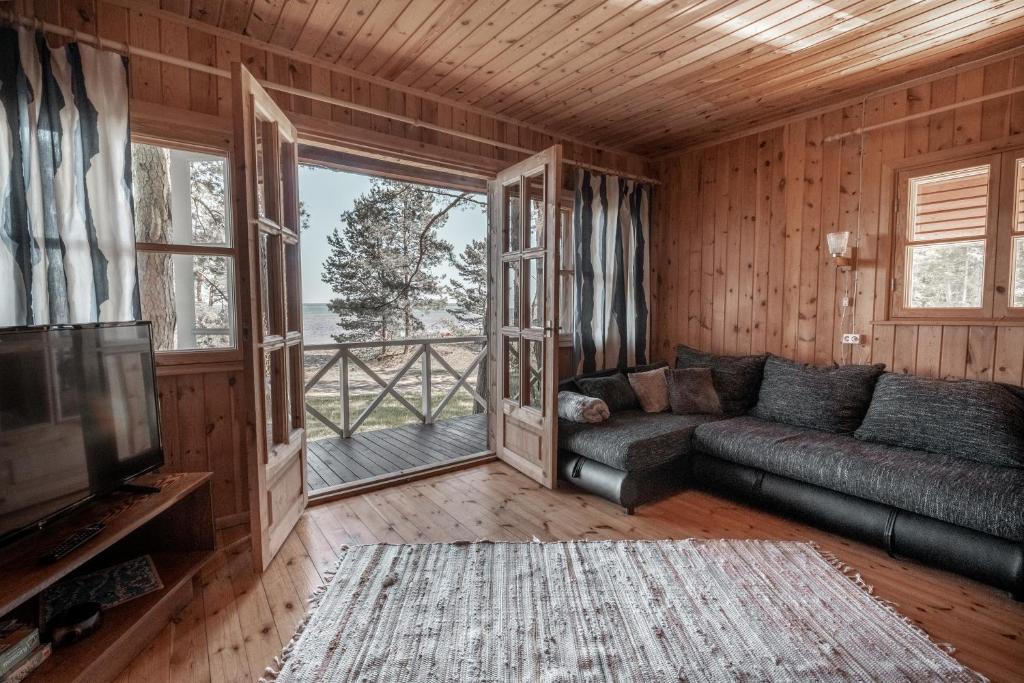 a living room with a couch and a large window at Ranniku Holiday House in Rannaküla