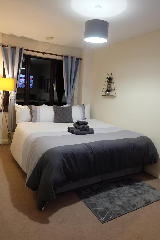 a bedroom with a large bed with a black blanket at 15 Bronant in Talgarth