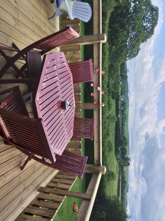 an overhead view of a group of chairs on a deck at la cabane des druides in Périgny