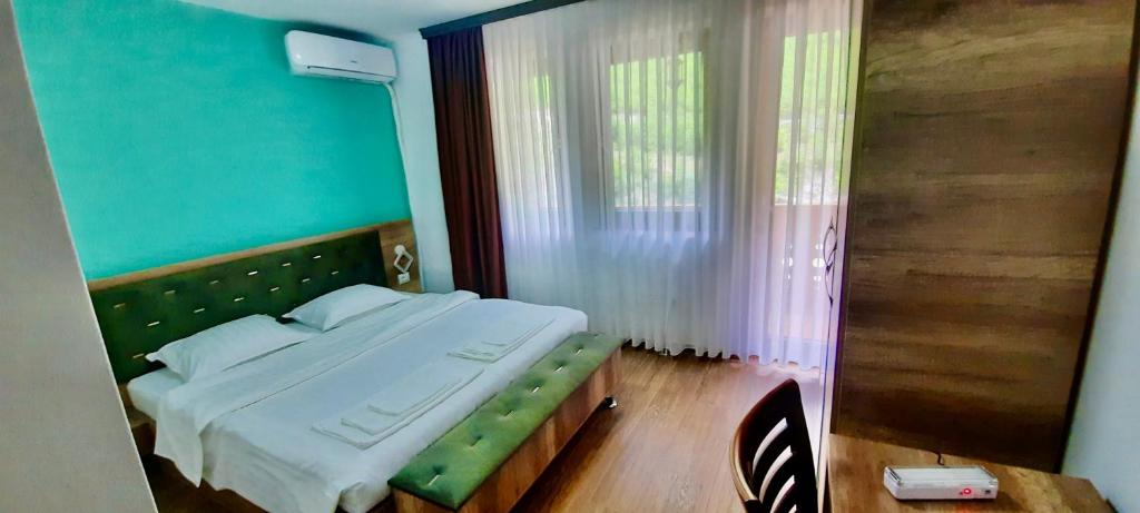 Postel nebo postele na pokoji v ubytování Vila Alexander B&B