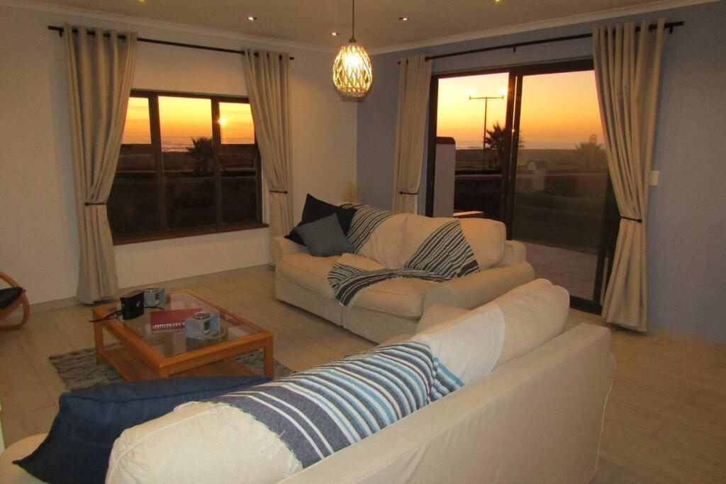 a living room with a couch and a table at Leander's Cottage - your dream stay in mind in Swakopmund
