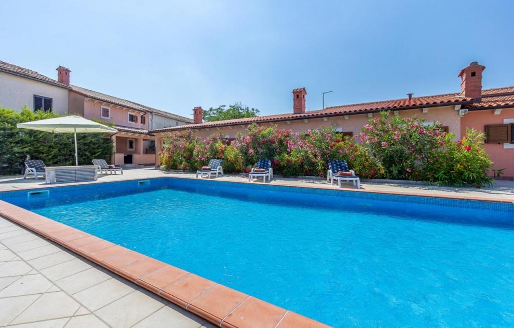 a swimming pool in front of a house at Country Villa (3642) in Loborika