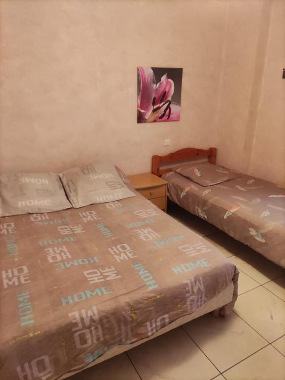 a room with two beds and a picture on the wall at Bousquet in Labatut