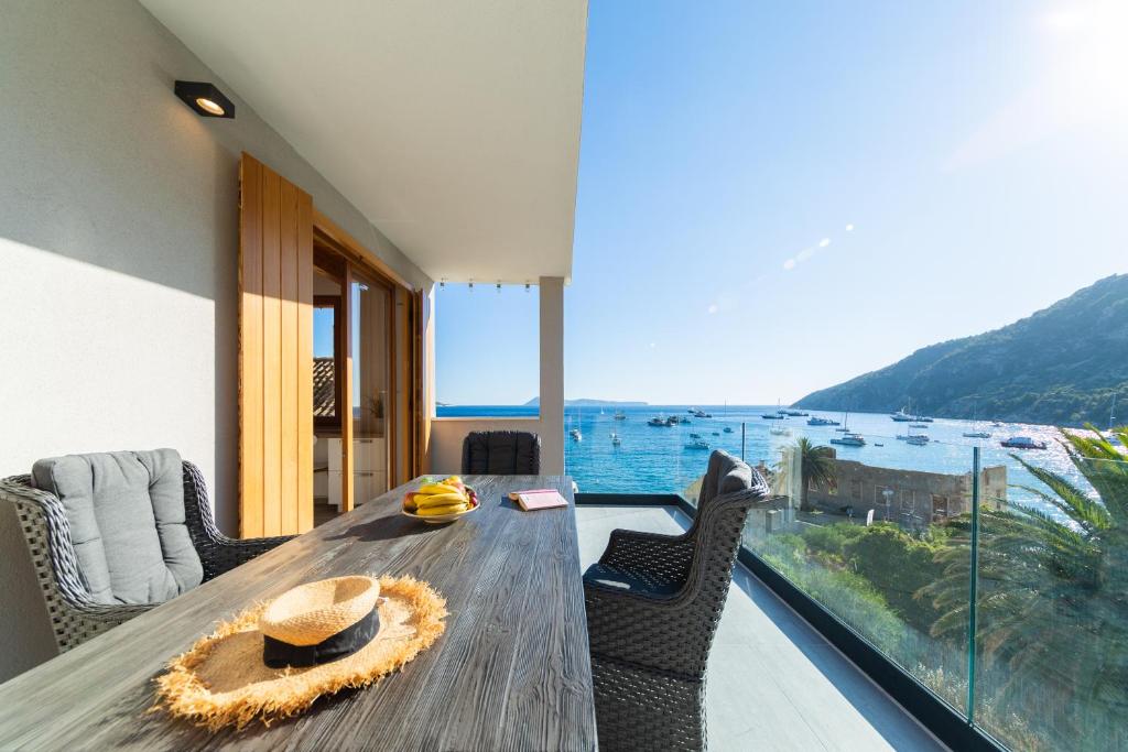 a dining room with a table and a view of the ocean at Villa Aida in Komiža