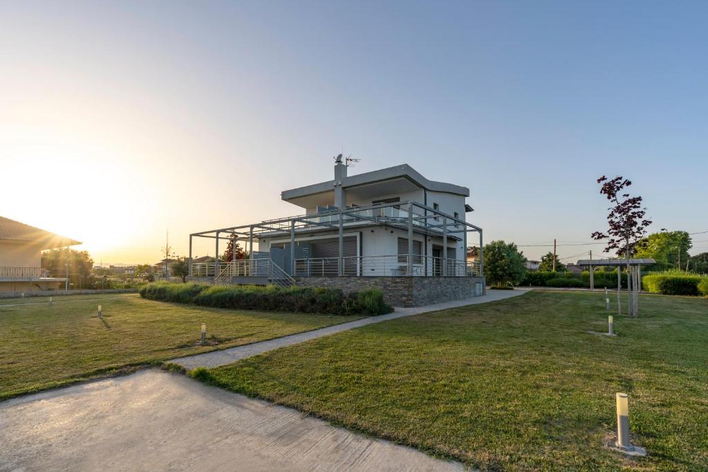 a house with a lawn in front of it at Villa Kyros in Korinos