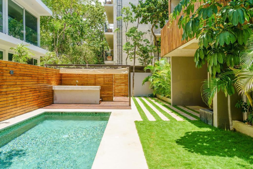 a swimming pool in the backyard of a house at Chic Suites in the Heart of Tulum by Stella Rentals in Tulum