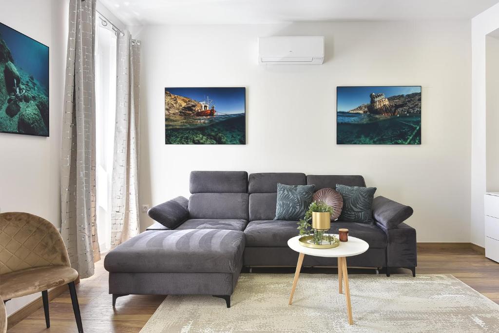 a living room with a couch and a table at D&A Central Luxury Apartments with FREE Parking in Pula