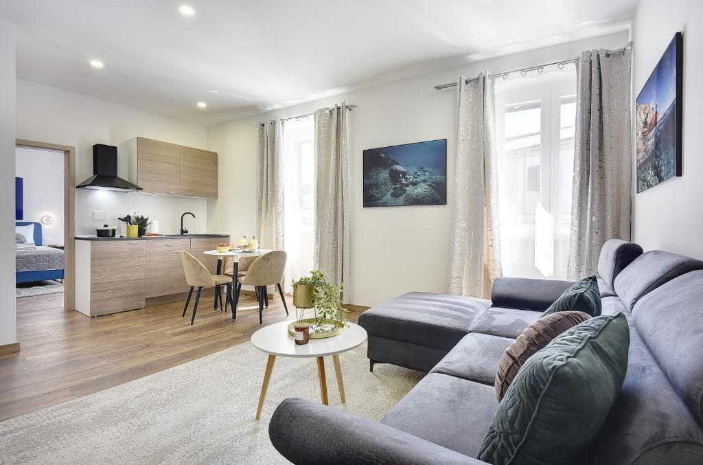 a living room with a couch and a table at D&A Central Luxury Apartments with FREE Parking in Pula