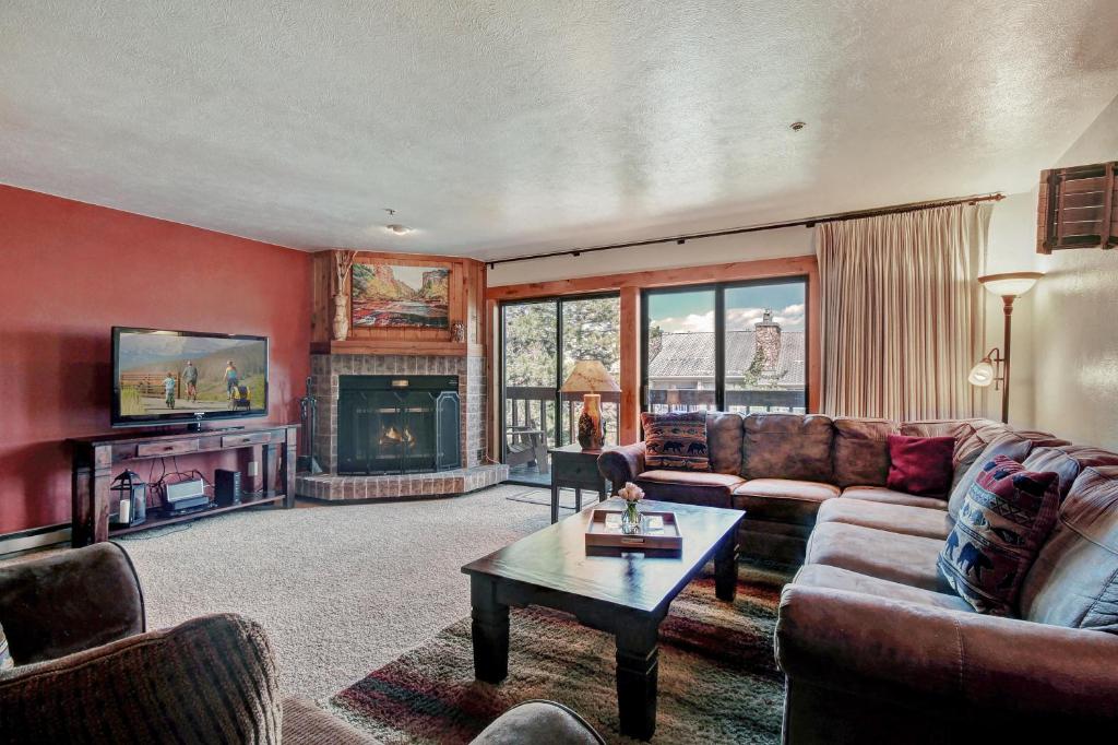 a living room with a couch and a fireplace at Cimmaron 301 in Breckenridge