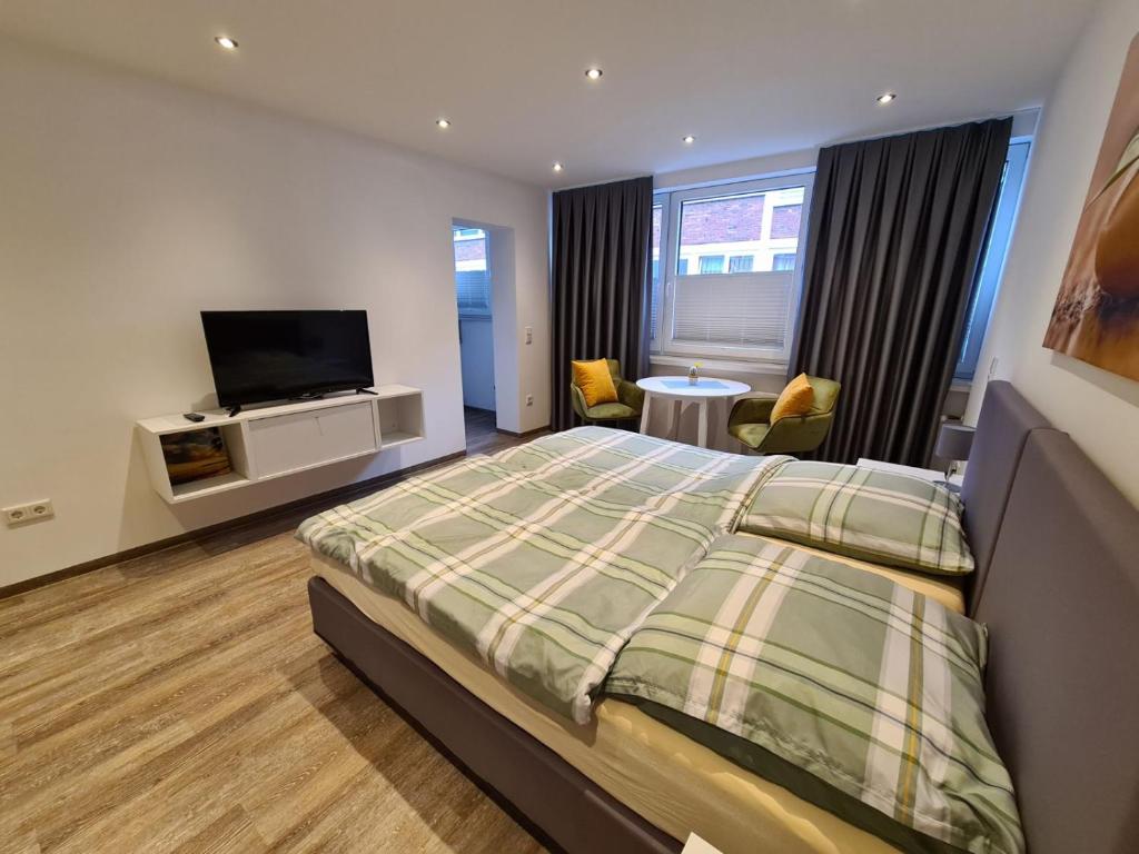 a bedroom with a bed and a flat screen tv at Apartment Jakimovski in Wuppertal