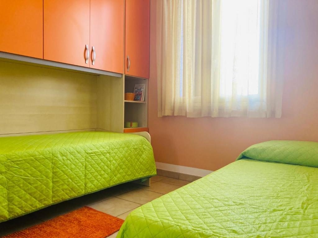 Łóżko lub łóżka w pokoju w obiekcie LA CONCHIGLIA