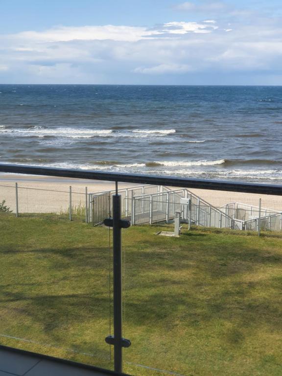 a view of the ocean from the balcony of a beach at Apartament Marzanna w Willi na Klifie in Rewal