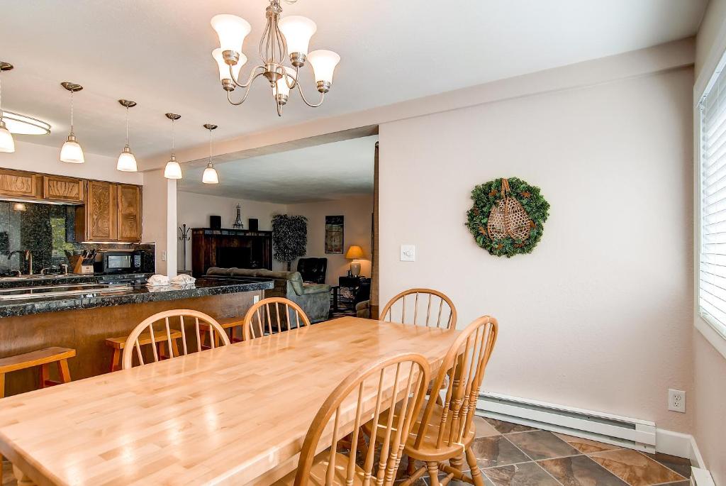 a kitchen and dining room with a wooden table and chairs at Park Place 102C in Breckenridge