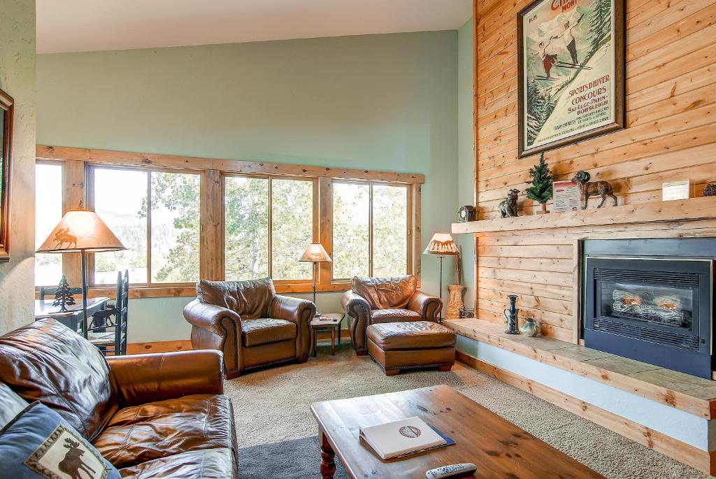 a living room with couches and a fireplace at Ski Hill 32 in Breckenridge