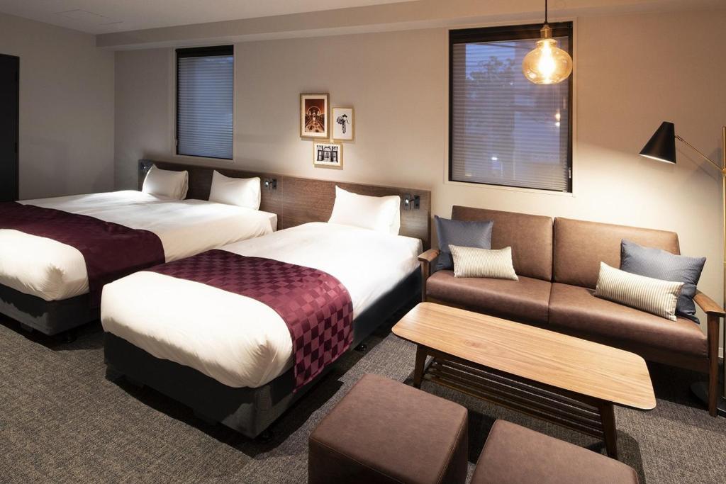 Postel nebo postele na pokoji v ubytování ALPHABED INN 小樽駅前