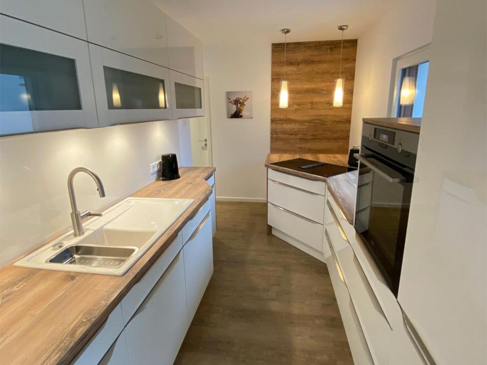 a kitchen with a sink and a stove at Ferienwohnung Bauer in Eppingen