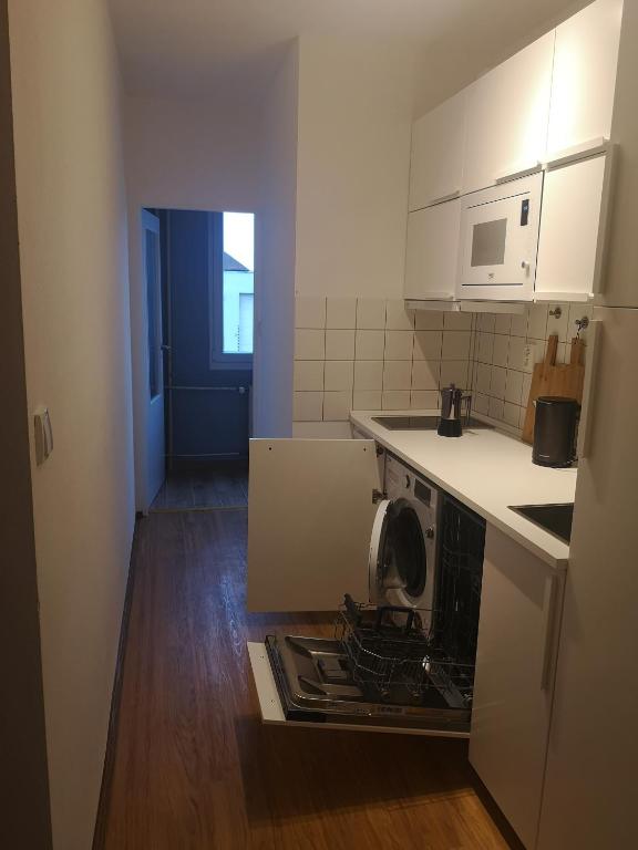 a small kitchen with a stove top oven in the floor at Apartmán Spa Šumava in Zdíkov