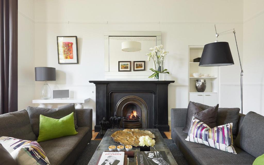 a living room with two couches and a fireplace at 94DR in Edinburgh