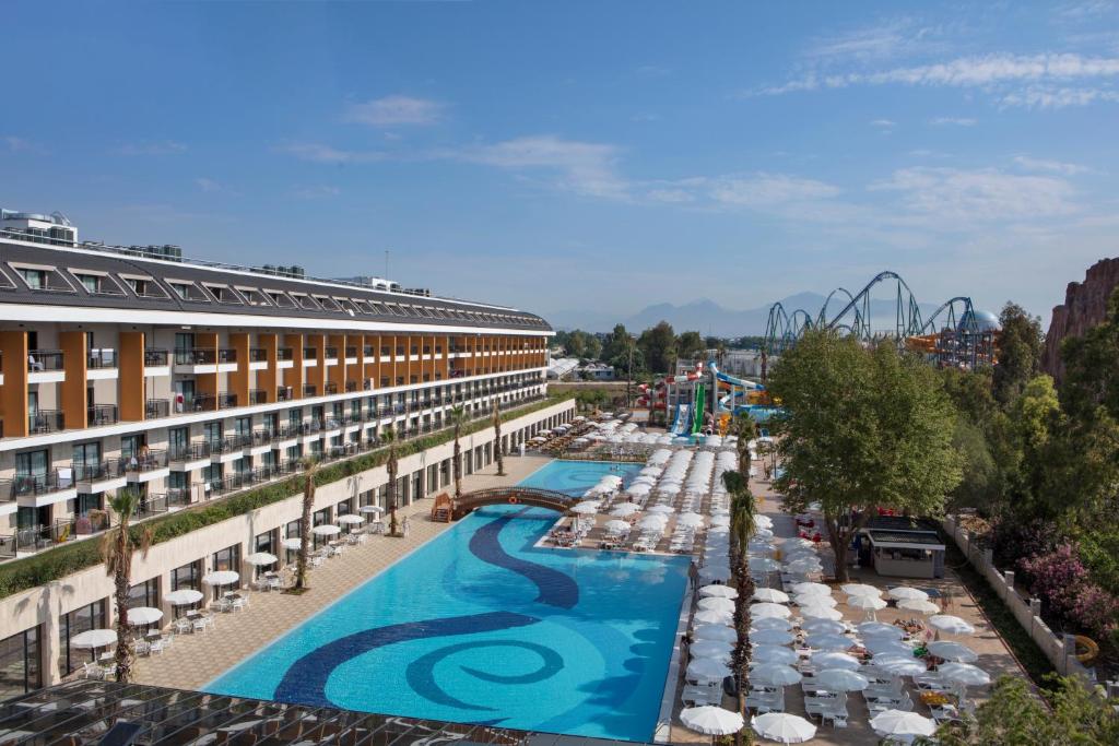a resort with a pool and a roller coaster at Aydinbey Queen’s Palace & SPA in Belek