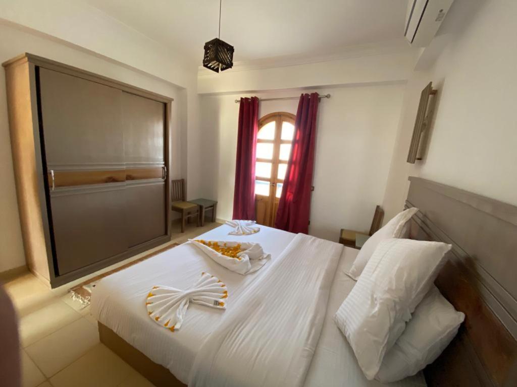 a white bed with a bowl of food on it at Villa 22 in Dahab