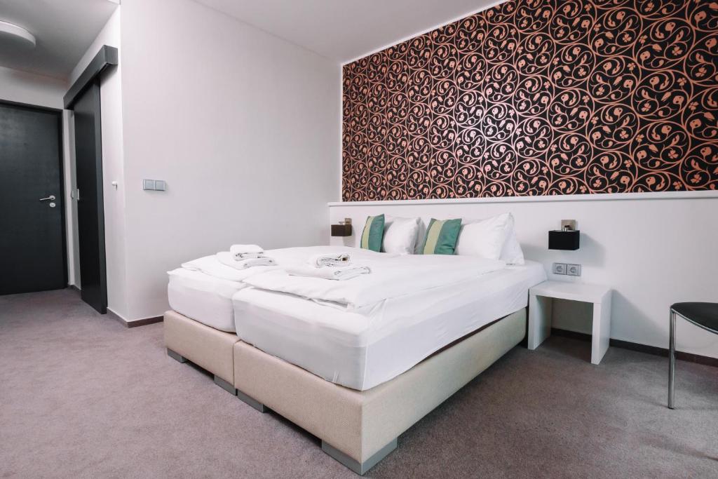 Postel nebo postele na pokoji v ubytování K-Triumf Resort