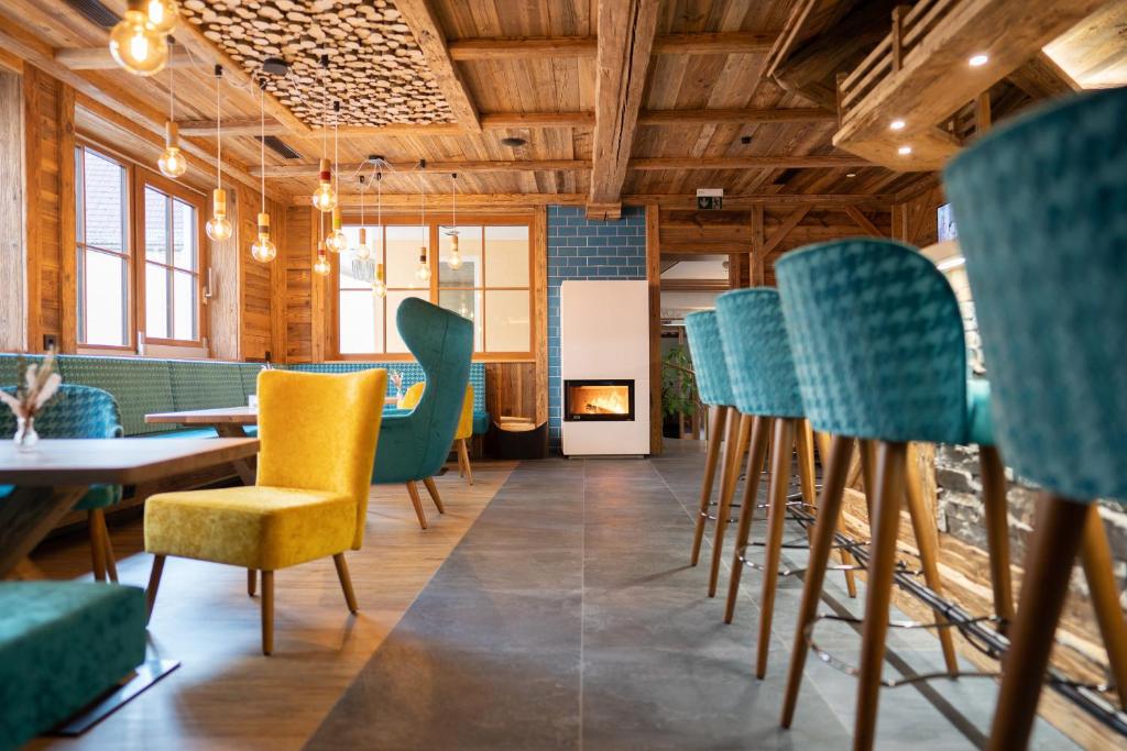 a restaurant with chairs and tables and a fireplace at Hotel Adler - Paulas Alb in Ehingen