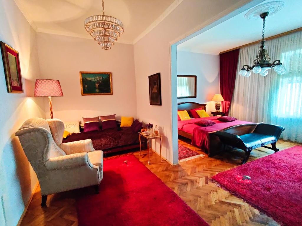 a bedroom with a bed and a red rug at 2 on seven in Zagreb