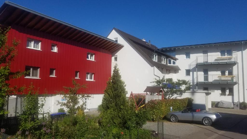 ein Auto, das auf einem Parkplatz zwischen zwei Gebäuden parkt in der Unterkunft Ferienwohnung Sonnenschein in Rheinhausen