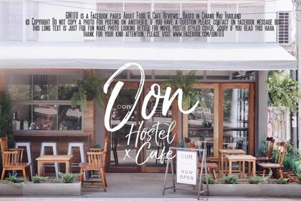a restaurant with a sign that reads om hostel cafe at Oon Poshtel x Cafe in Chiang Mai