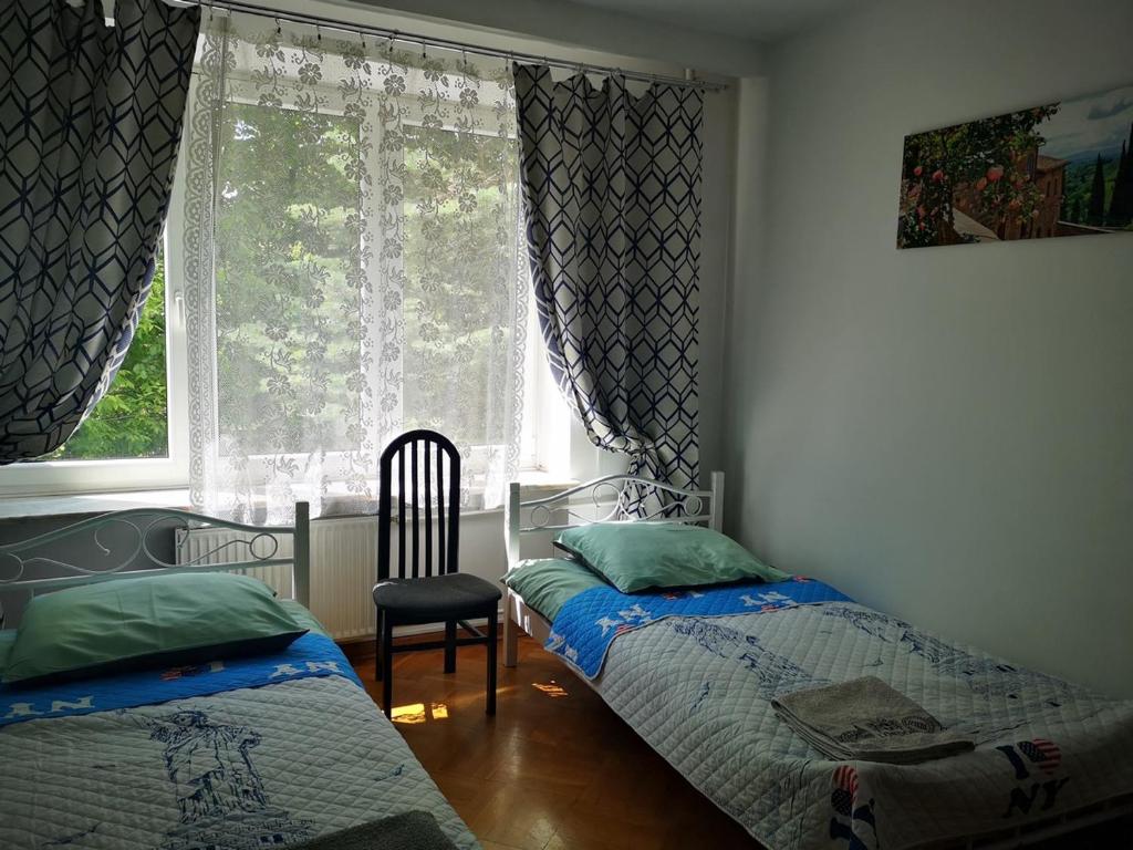 sypialnia z 2 łóżkami i oknem w obiekcie Mira Rent House w Warszawie