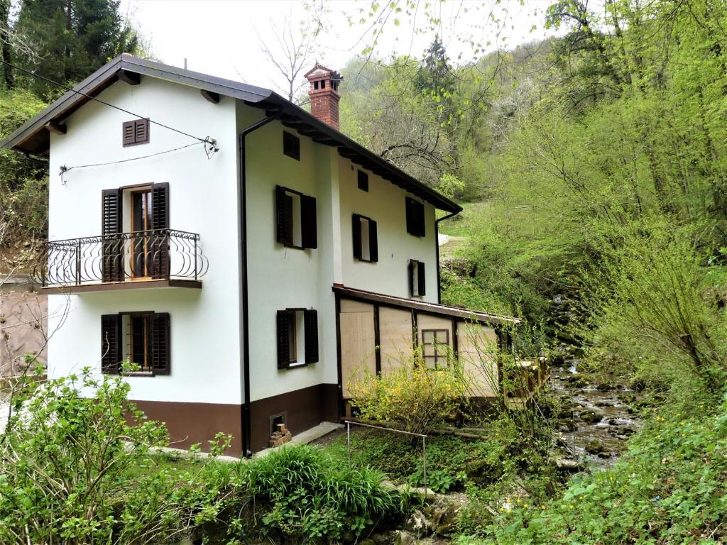 a house on the side of a hill at Hiša ob potoku in Avče