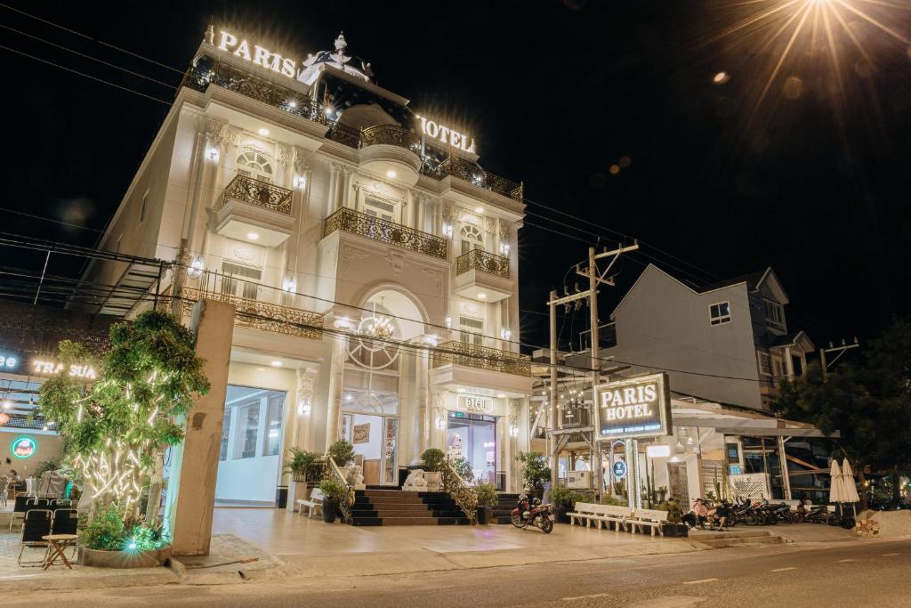a large white building with lights on it at night at Paris Hotel Bình Thuận in Tuy Phong