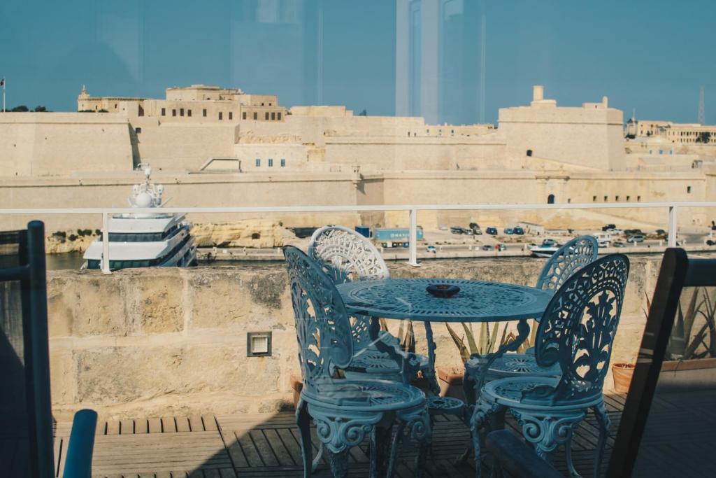 a table and chairs with a view of the city at Sally Port Senglea in Senglea