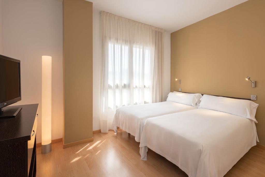 Postel nebo postele na pokoji v ubytování Madrid Airport Suites, Affiliated by Meliá