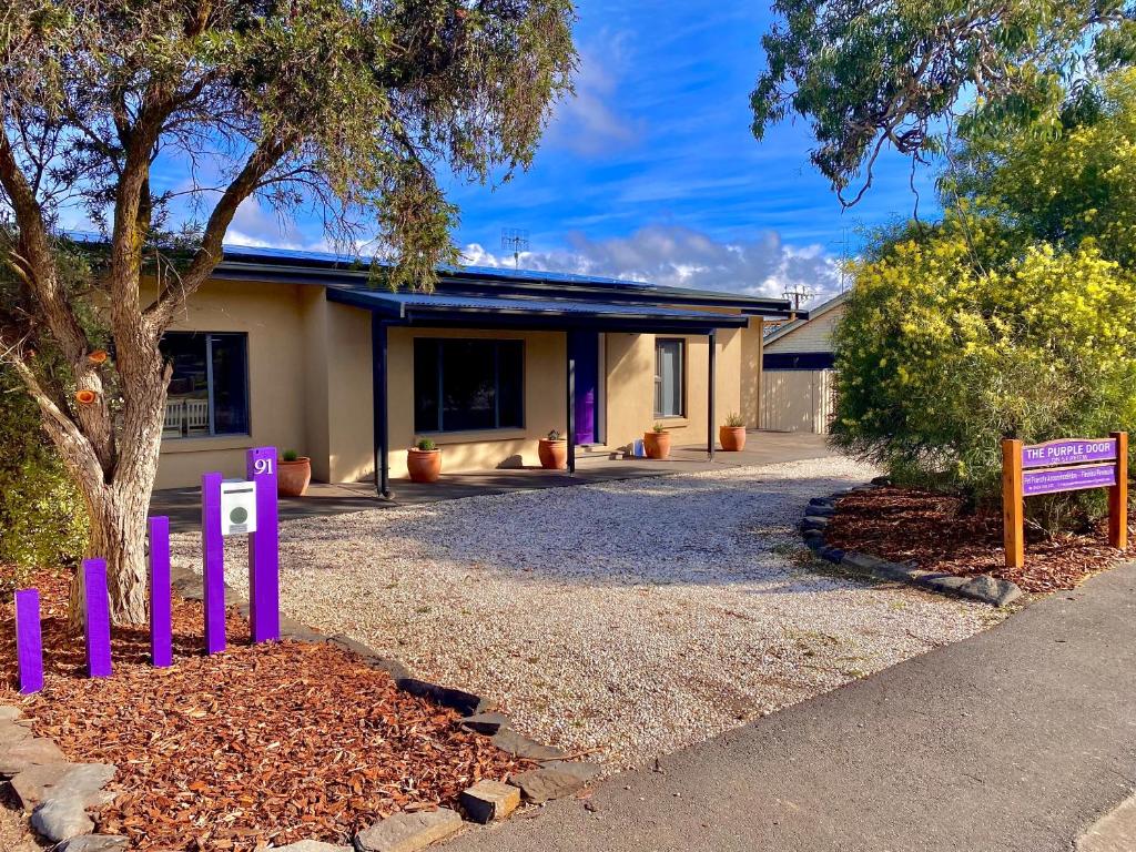 a house with a purple fence in front of it at The Purple Door on Seaview in Victor Harbor