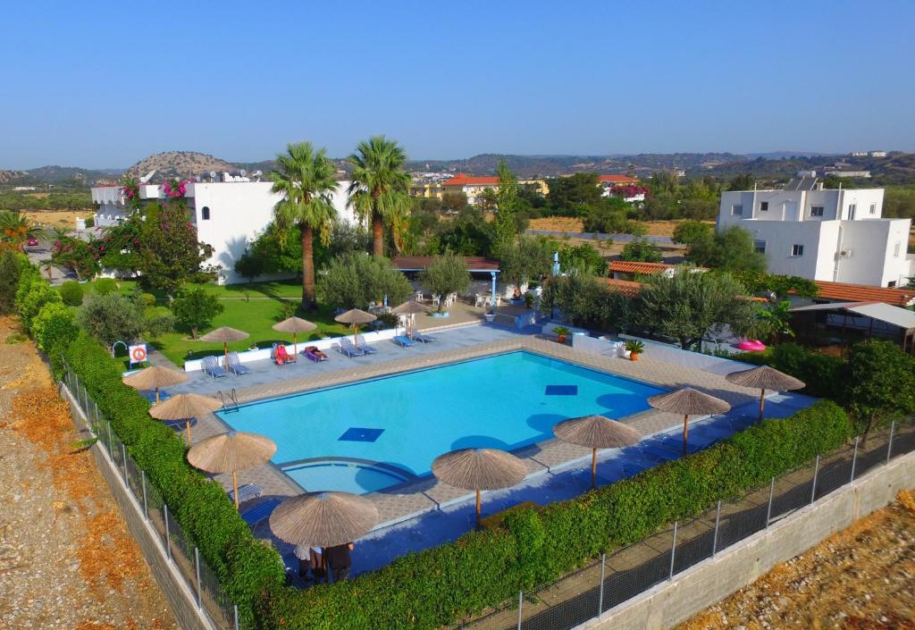 an overhead view of a swimming pool with umbrellas at HOTEL TINA FLORA in Kolymbia