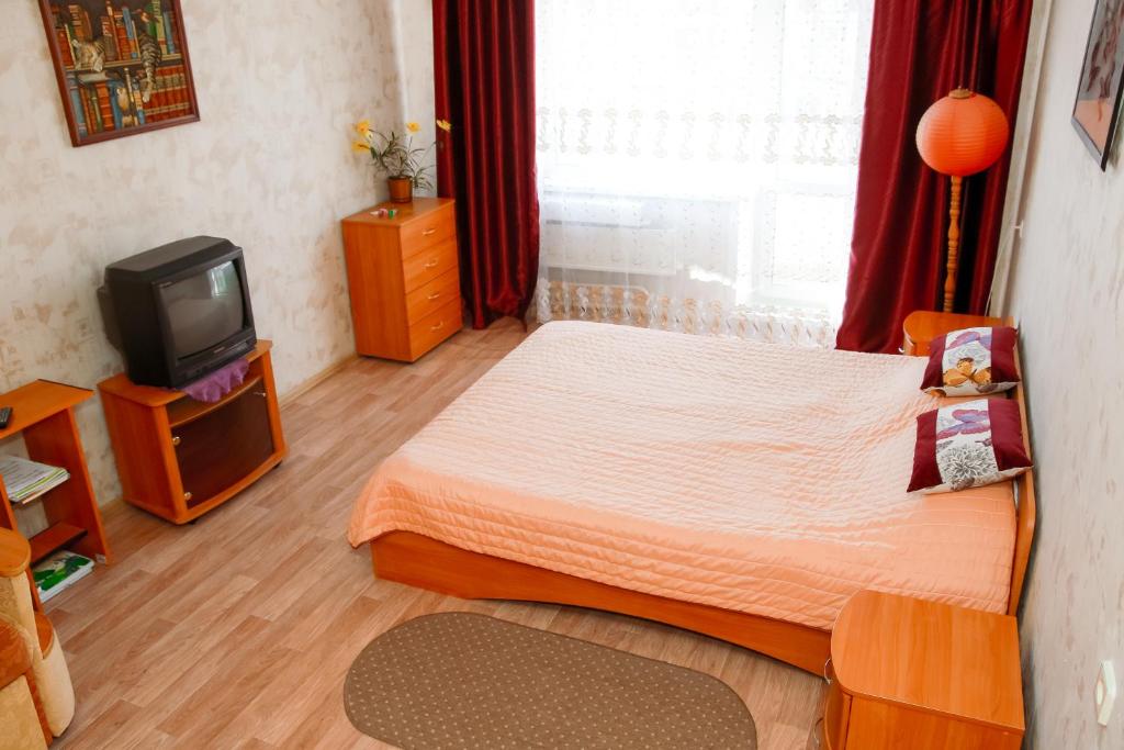 オムスクにあるApartment on 70 let Oktyabryaの小さなベッドルーム(ベッド1台、テレビ付)