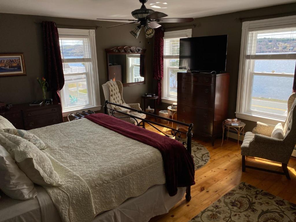 a bedroom with a bed and a flat screen tv at Toba's Bed & Breakfast in East LaHave