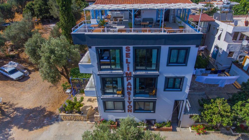 an overhead view of a blue house with a balcony at Selim Pansiyon in Kas