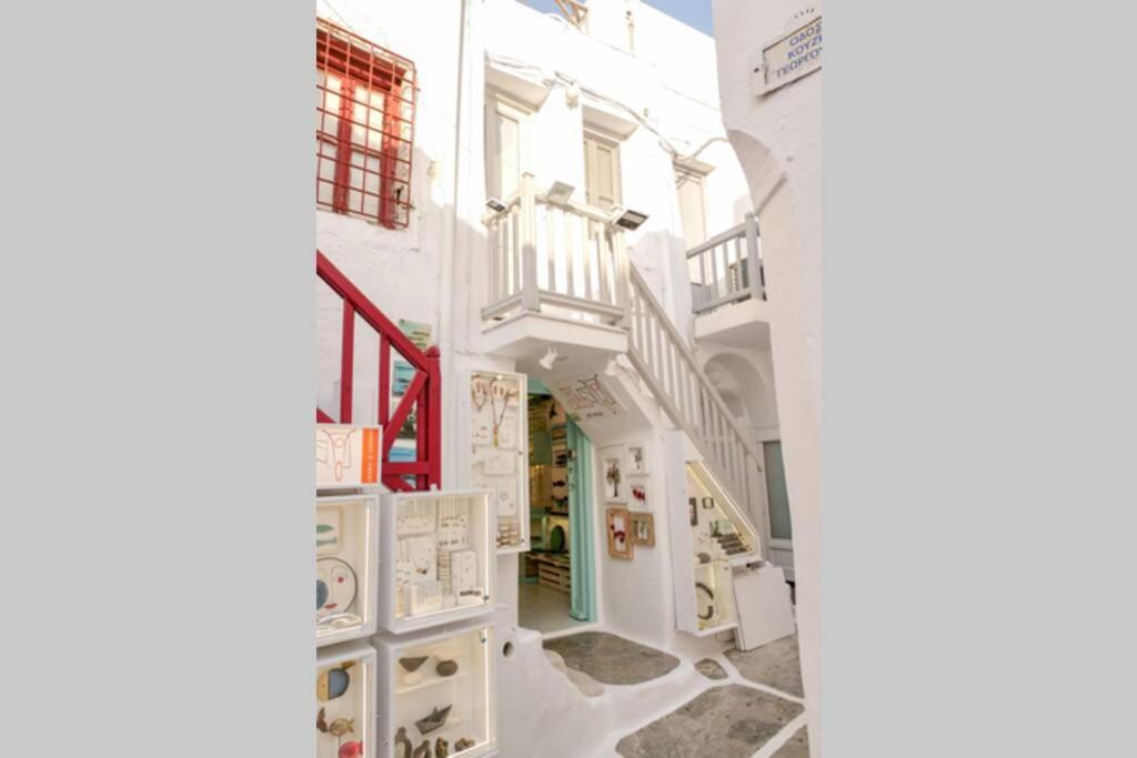 a building with white walls and white floors at Traditional Myconian Studio in the heart of Chora in Mikonos