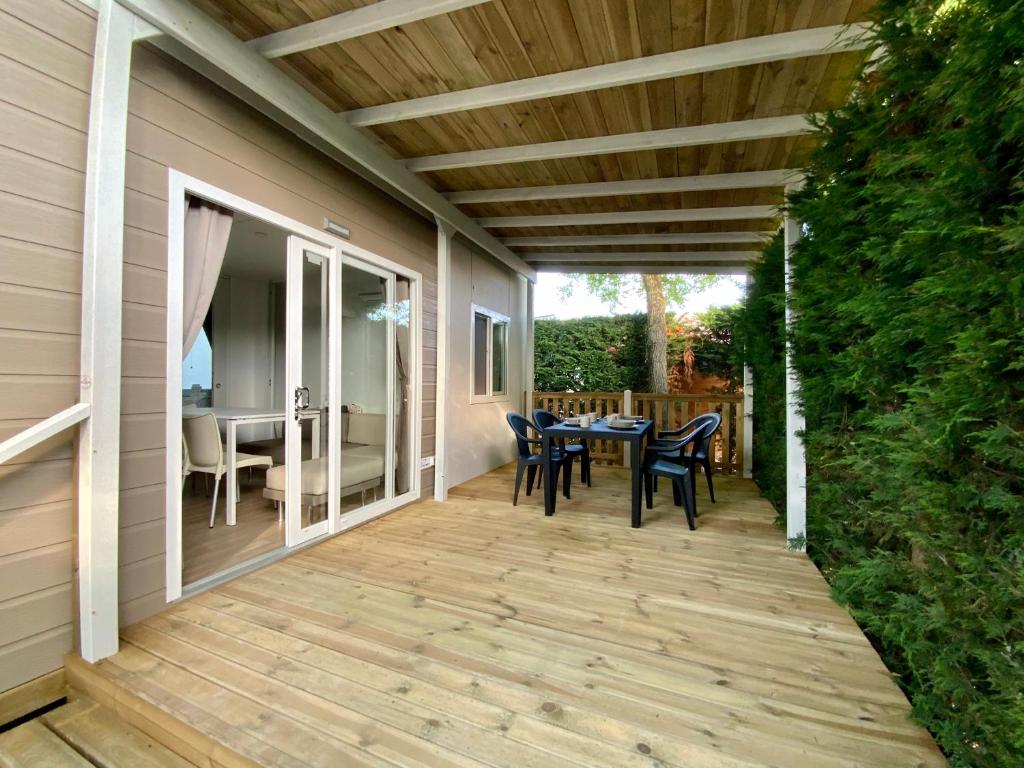 a patio with a table and chairs on it at Volare Camp in Villaggio San Francesco in Duna Verde