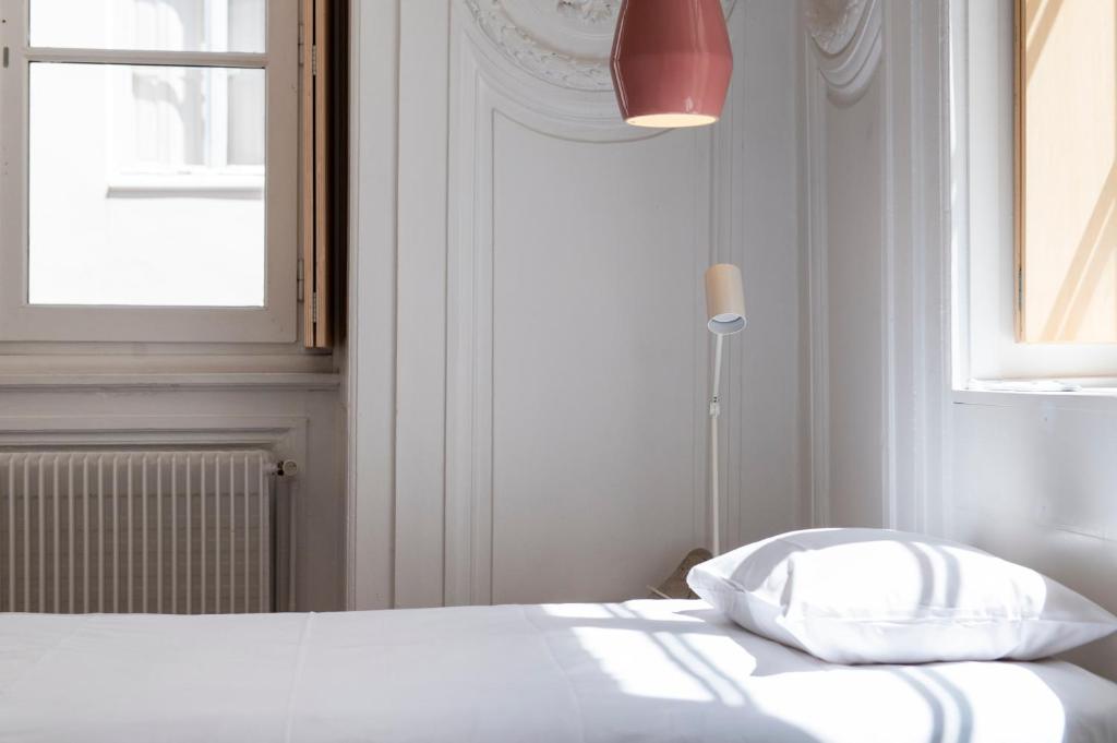 Postel nebo postele na pokoji v ubytování SLO Hostel Lyon les Pentes