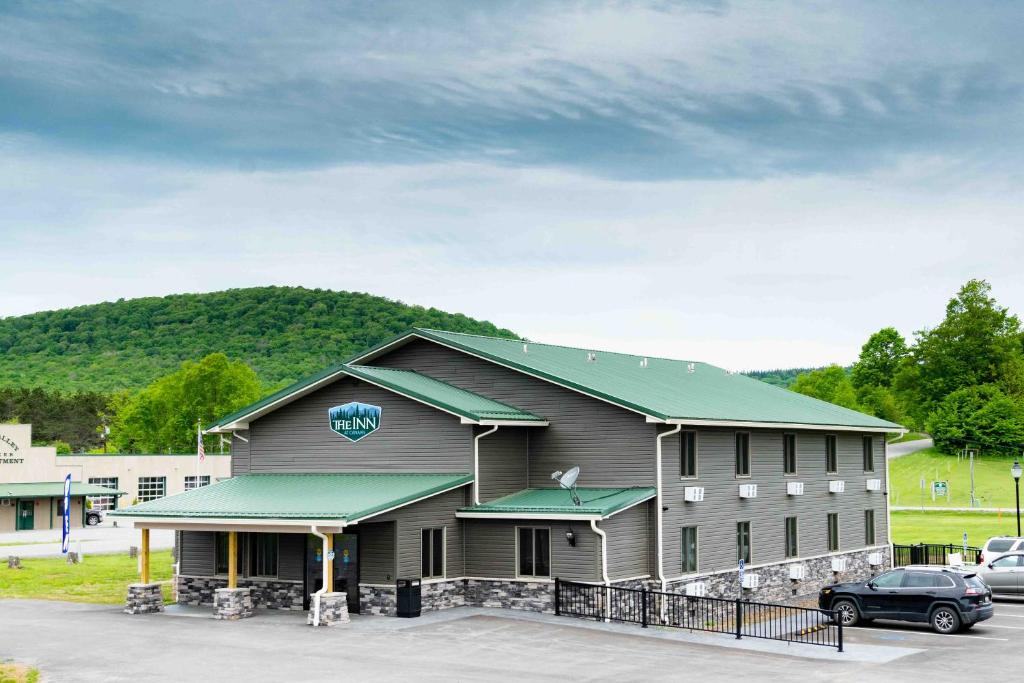 a large building with a car parked in a parking lot at The Inn at Canaan in Davis