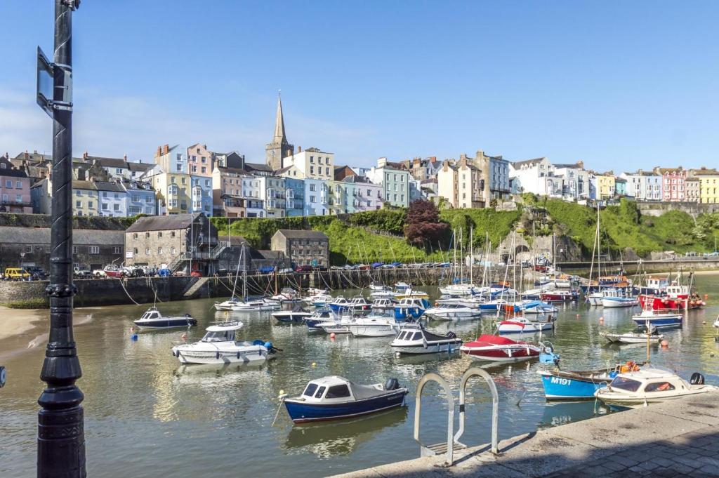 a bunch of boats are docked in a harbor at North Beach Heights - 2 Bedroom Penthouse - Tenby in Tenby