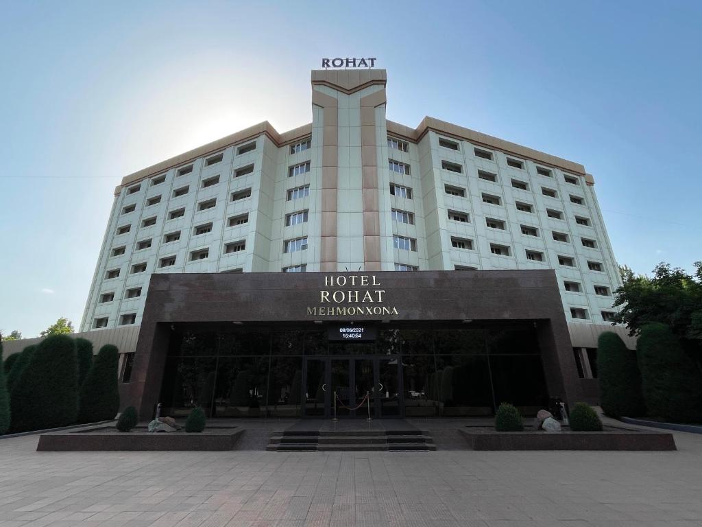 a hotel with a sign on the front of it at Rohat Hotel Chilonzor in Tashkent