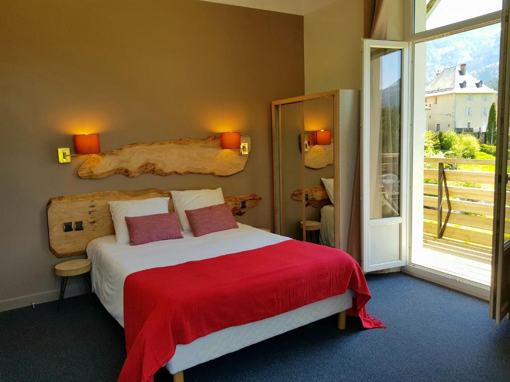 Postel nebo postele na pokoji v ubytování Hotel Le Beau Site