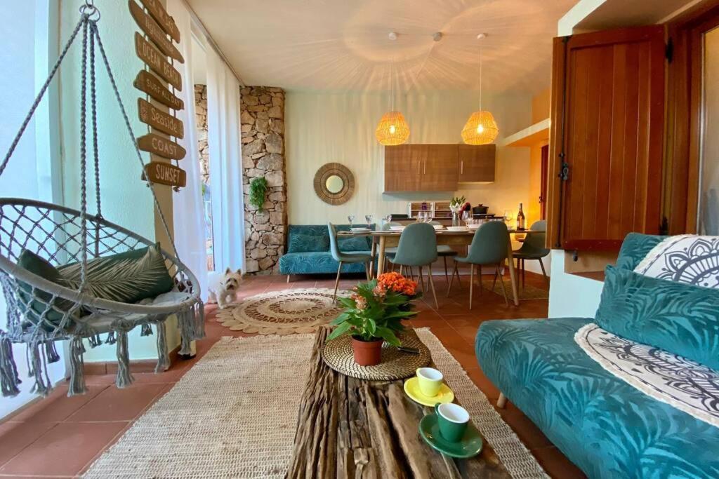 a living room with a couch and a table at Boho Chic Beach Resort in Sardegna in Porto Istana
