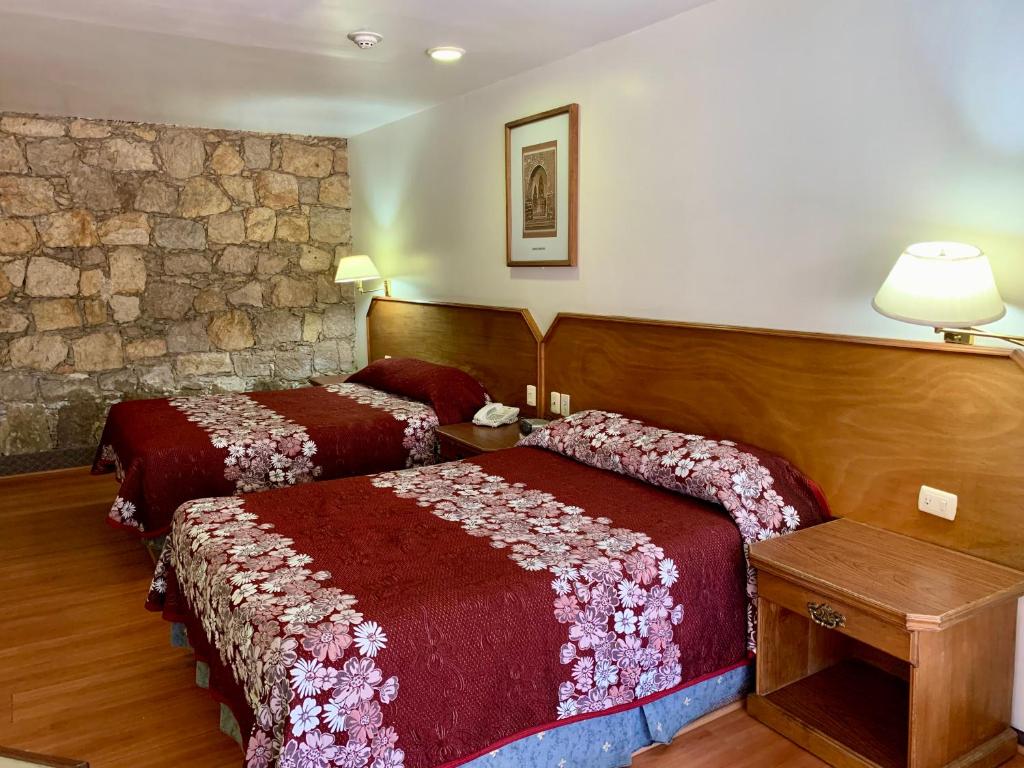 Postel nebo postele na pokoji v ubytování Hotel Posada Vista Bella