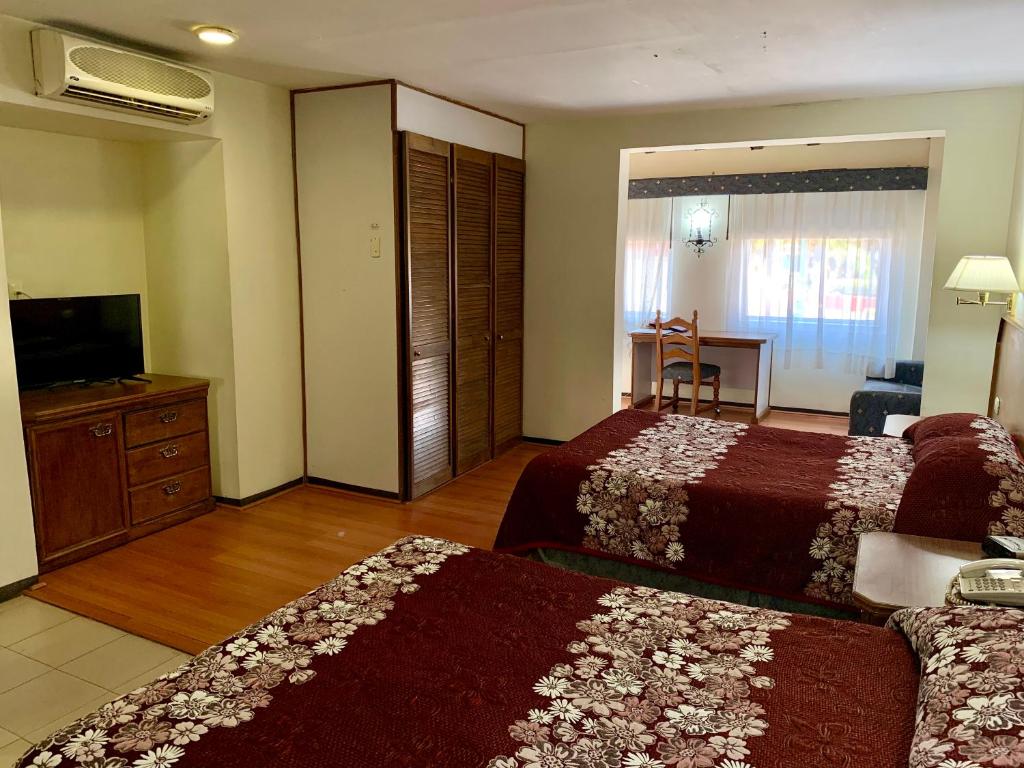 Postel nebo postele na pokoji v ubytování Hotel Posada Vista Bella